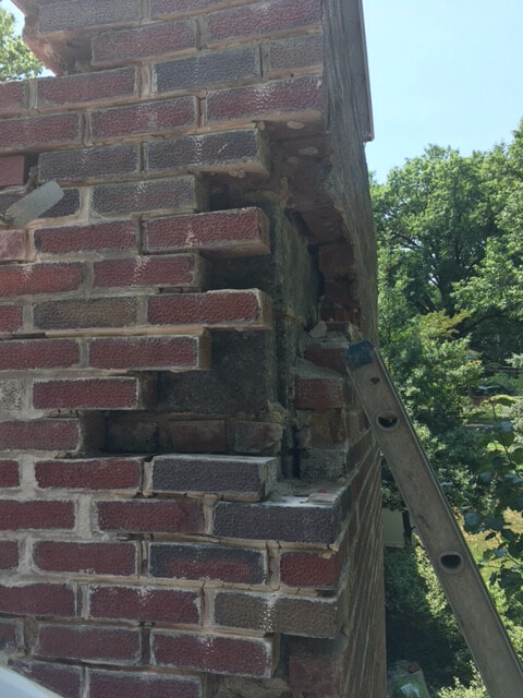 Chimney being rebuilt above the roofline